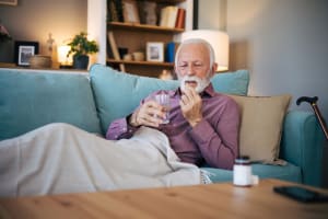 Person resting at home and taking medicine after the procedure.