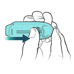 Thumb pushing on dose release lever on side of inhaler.