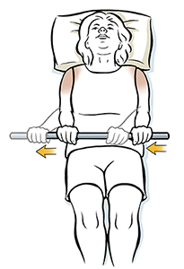Woman lying on back holding wand, doing external rotation shoulder exercise.