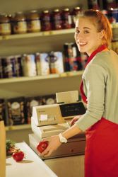 Teen girl work as a cashier at a grocery store